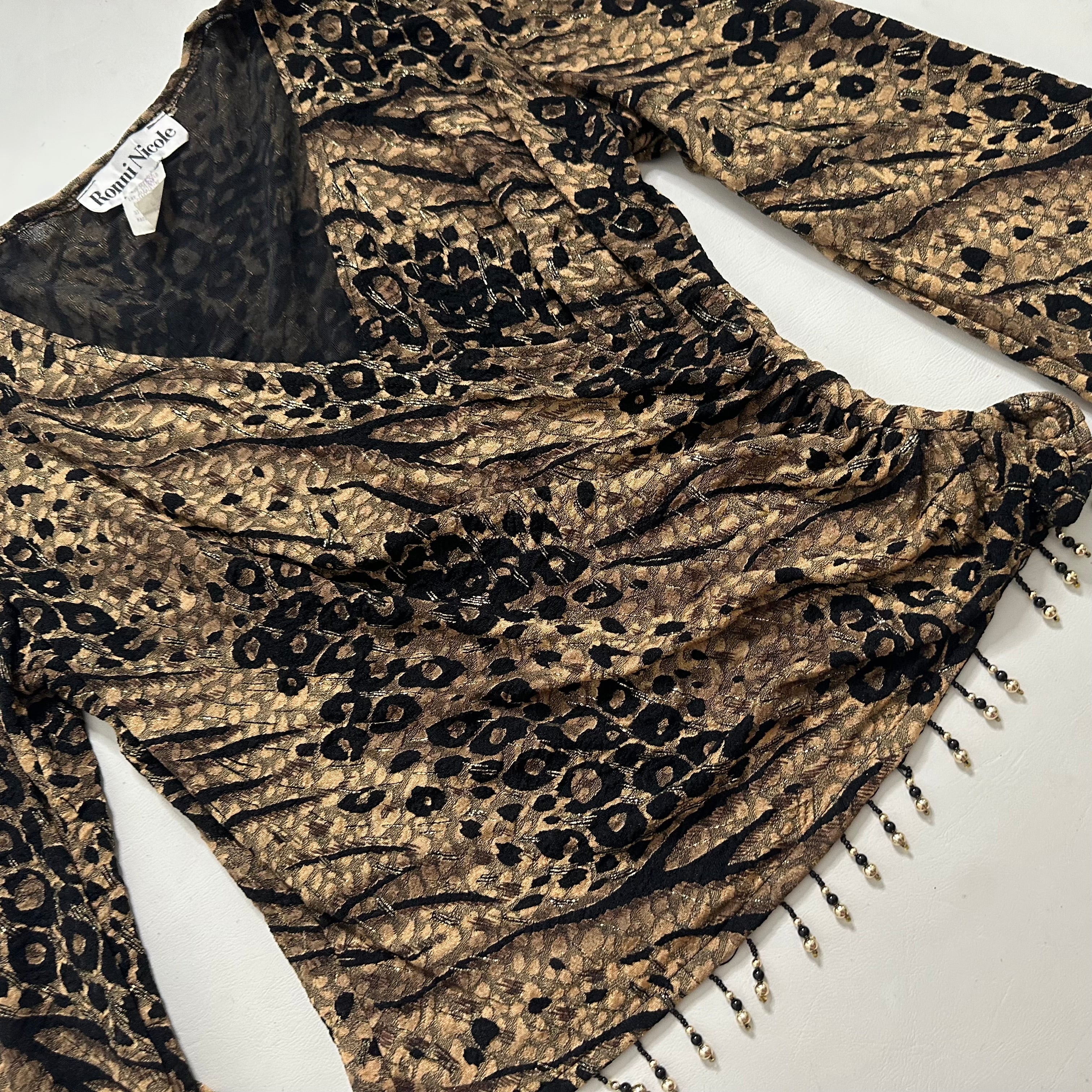 Wrap over animal print top with beads